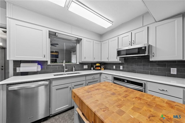 3921 Cripple Creek Dr, Temple, TX 76502 - kitchen with stainless steel appliances, a sink, butcher block countertops, backsplash, and gray cabinets
