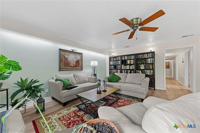 3921 Cripple Creek Dr, Temple, TX 76502 - living area with wood finished floors, ceiling fan, and baseboards