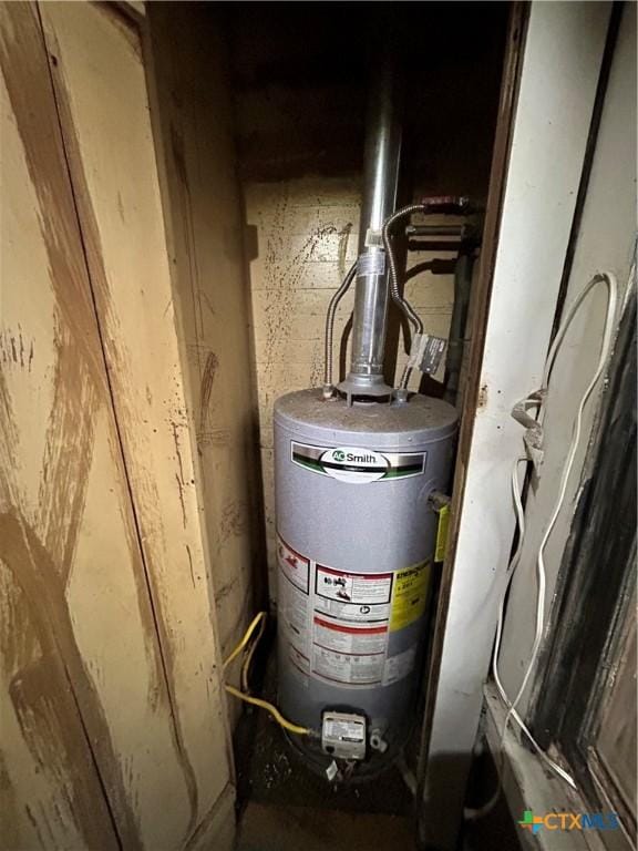 utility room featuring gas water heater