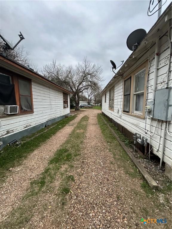 view of side of home featuring cooling unit