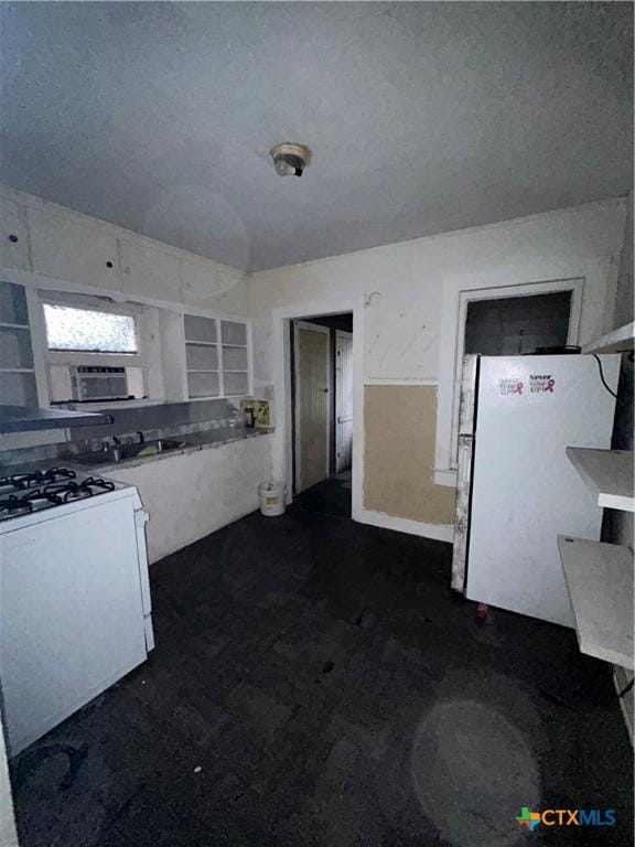 kitchen featuring white appliances and a textured ceiling