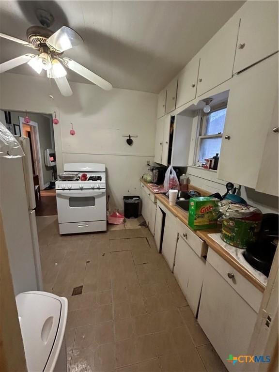 kitchen featuring light countertops, white appliances, white cabinetry, and a ceiling fan