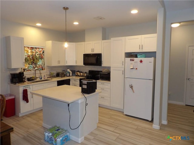 930 Redwood, Rockport, TX 78382 - kitchen featuring black appliances, white cabinetry, light countertops, backsplash, and recessed lighting