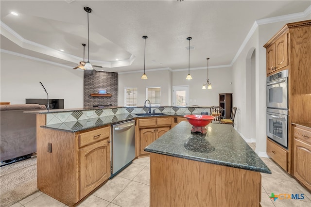 kitchen featuring crown molding, sink, a spacious island, and appliances with stainless steel finishes