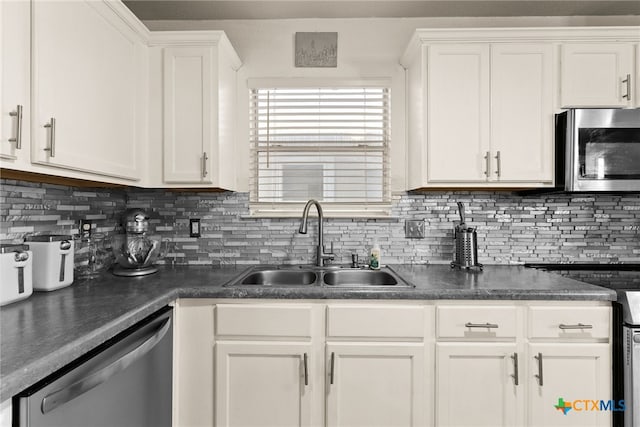 kitchen featuring tasteful backsplash, white cabinetry, sink, and appliances with stainless steel finishes