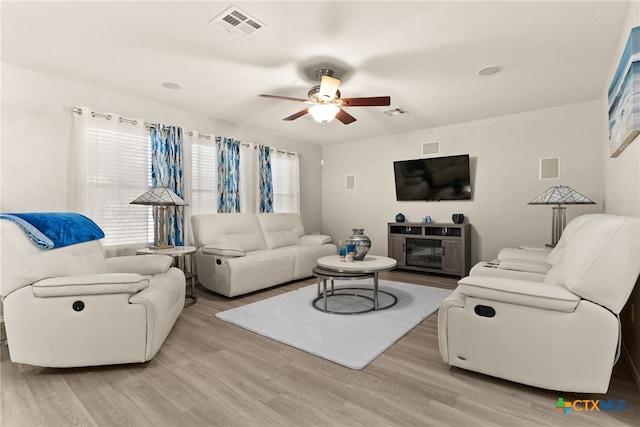 living room featuring ceiling fan and light wood-type flooring