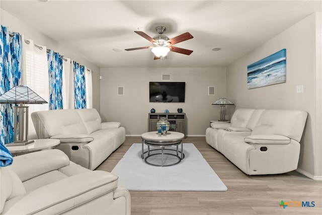 living room with ceiling fan and light hardwood / wood-style floors