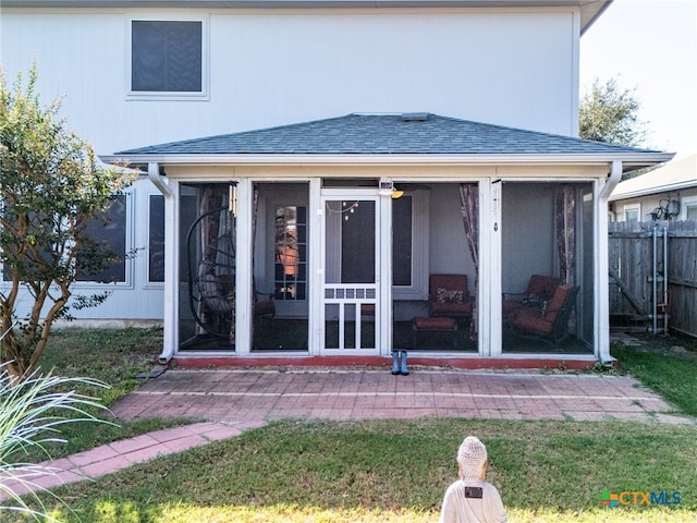 back of house with a sunroom