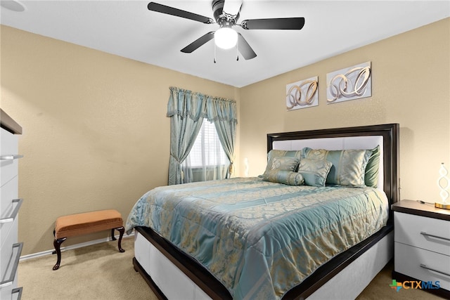 bedroom with ceiling fan and light carpet