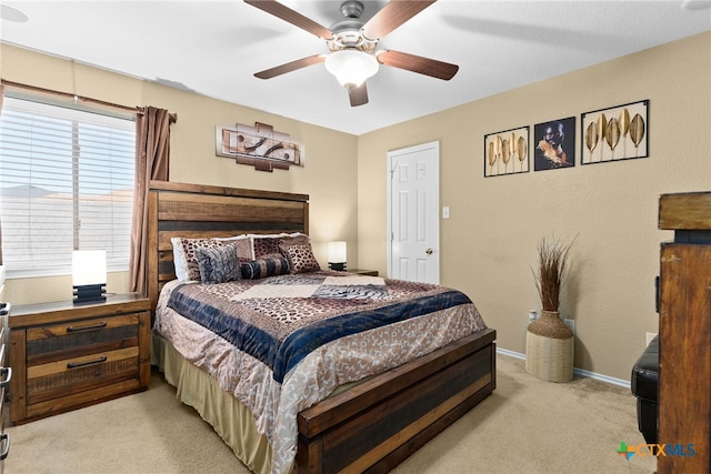 carpeted bedroom with multiple windows and ceiling fan