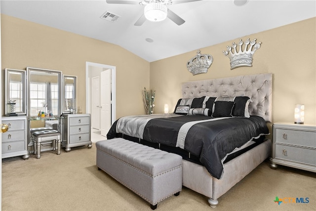 bedroom with ceiling fan, light colored carpet, and vaulted ceiling