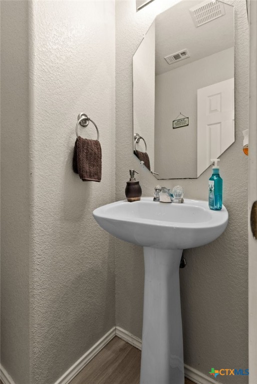 bathroom with hardwood / wood-style flooring