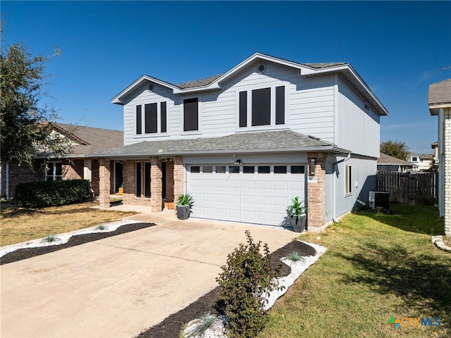 front facade featuring a garage, a front lawn, and central air condition unit