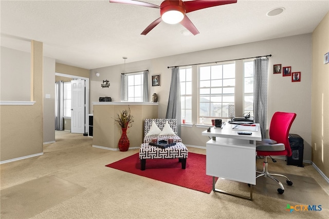 carpeted office featuring ceiling fan