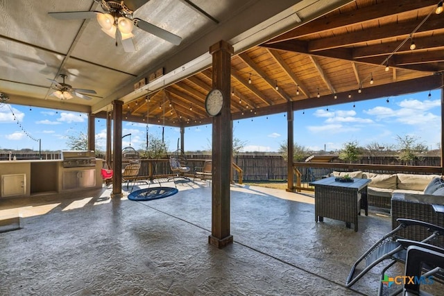 view of patio / terrace featuring a ceiling fan, fence, grilling area, exterior kitchen, and an outdoor hangout area