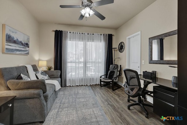 office space featuring wood finished floors, baseboards, and ceiling fan