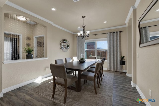 dining area with baseboards, dark wood-type flooring, a chandelier, and crown molding