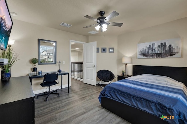 bedroom featuring visible vents, baseboards, and wood finished floors