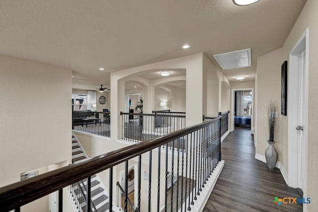 corridor with an upstairs landing, wood finished floors, recessed lighting, baseboards, and attic access