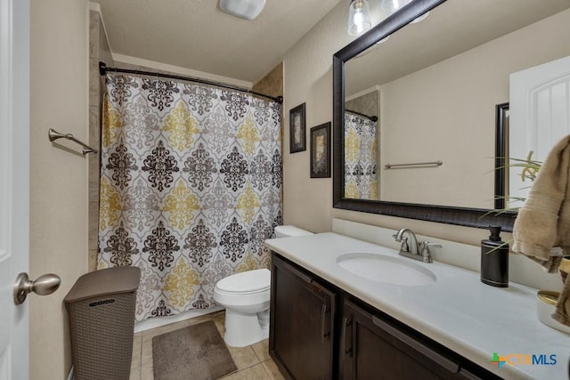 bathroom featuring vanity, a shower with shower curtain, toilet, and tile patterned flooring