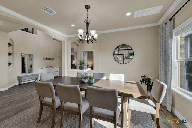 dining area featuring visible vents, an inviting chandelier, and ornamental molding