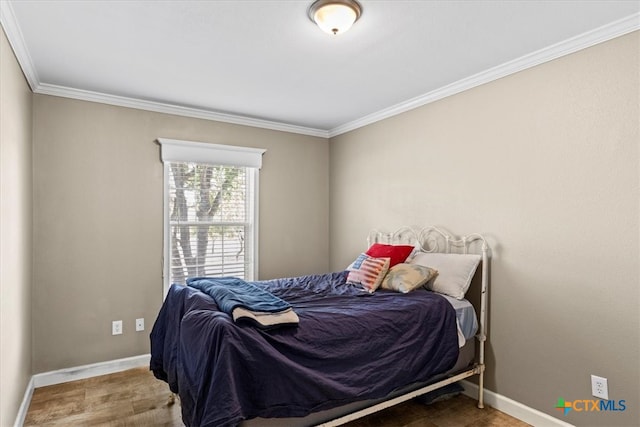 bedroom featuring wood-type flooring and ornamental molding