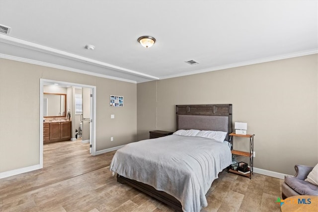 bedroom with ornamental molding, light hardwood / wood-style floors, and ensuite bath