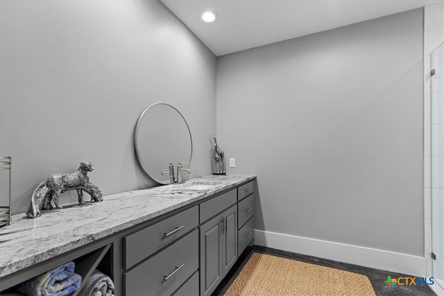 bathroom with walk in shower and vanity