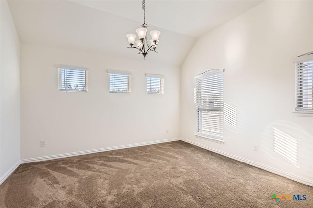 carpeted spare room featuring vaulted ceiling, an inviting chandelier, and plenty of natural light