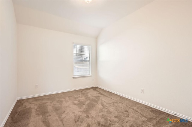 empty room with carpet and lofted ceiling