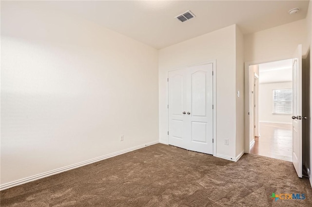 unfurnished bedroom featuring dark colored carpet