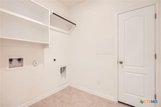 clothes washing area with hookup for a washing machine, gas dryer hookup, and electric dryer hookup