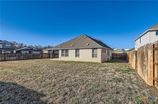 rear view of property featuring a yard