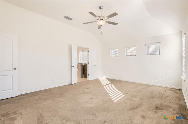 empty room with ceiling fan, light colored carpet, and lofted ceiling