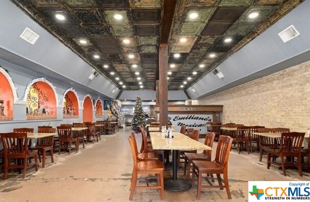 dining area with brick wall