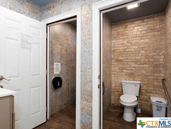 bathroom featuring vanity, hardwood / wood-style flooring, and toilet