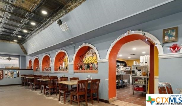 interior space featuring lofted ceiling and light tile patterned floors