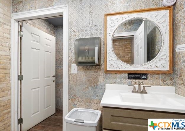 bathroom with hardwood / wood-style flooring, vanity, and toilet