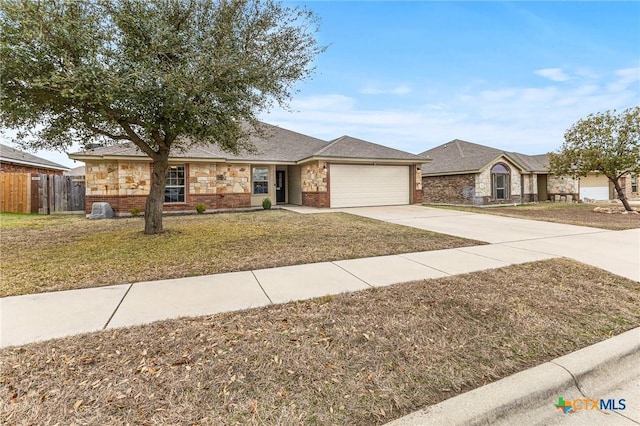 ranch-style home featuring a garage and a front yard