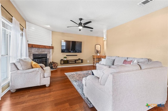 living room with ceiling fan and dark hardwood / wood-style flooring