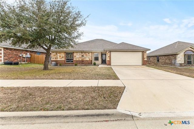 view of front of home with a garage and a front yard