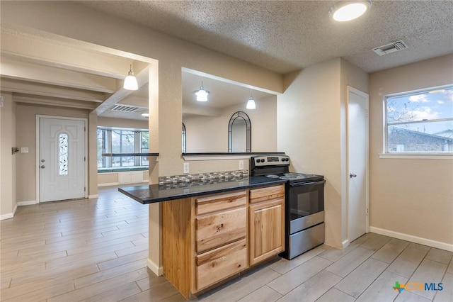 kitchen with dark countertops, decorative light fixtures, electric range, and wood finish floors