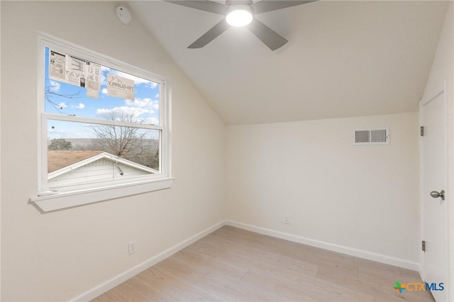 bonus room with lofted ceiling, light wood-style floors, visible vents, and baseboards