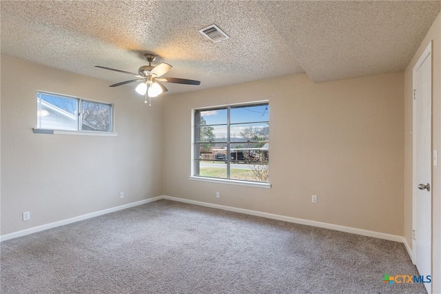 unfurnished bedroom with carpet floors, baseboards, visible vents, and a ceiling fan