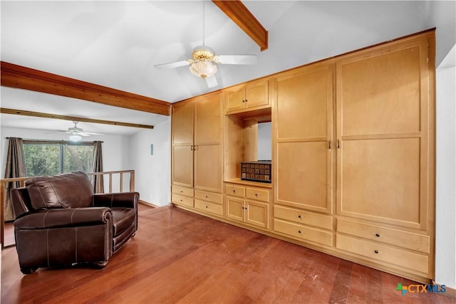 living room featuring ceiling fan, lofted ceiling with beams, and hardwood / wood-style floors