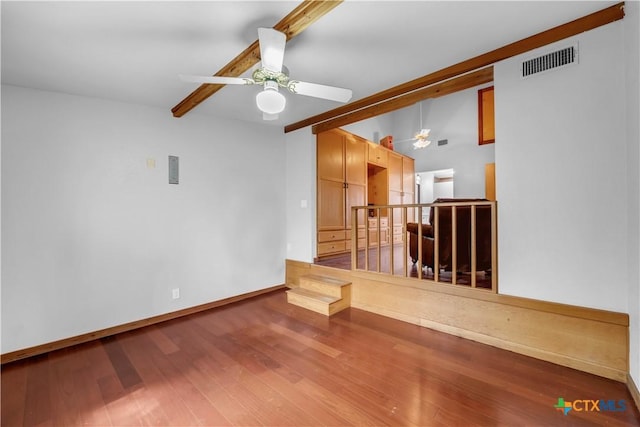 spare room with wood-type flooring, ceiling fan, and beam ceiling