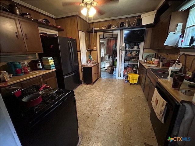 1511 E Constitution St, Victoria, TX 77901 - kitchen with black gas stove, a sink, a ceiling fan, freestanding refrigerator, and crown molding