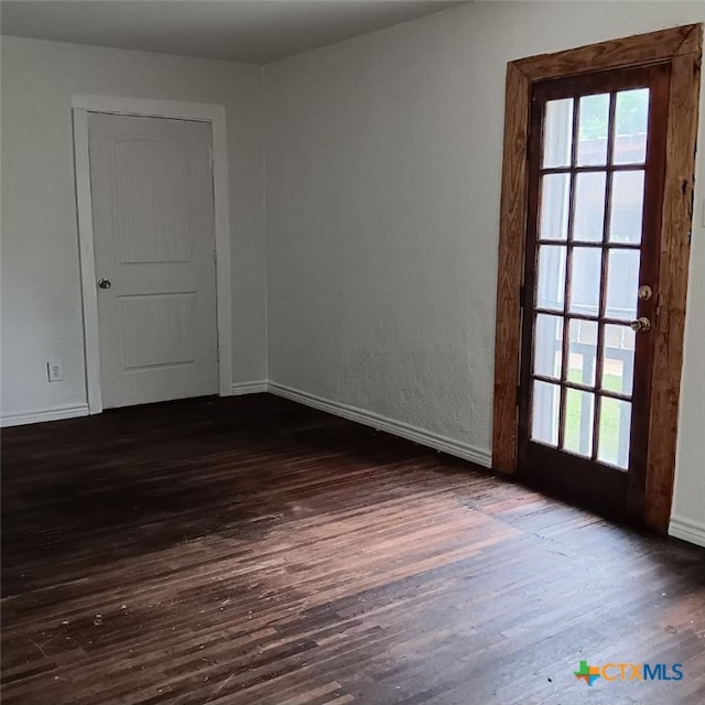 spare room with dark wood-type flooring