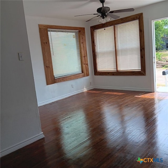 unfurnished room featuring ceiling fan and dark hardwood / wood-style floors