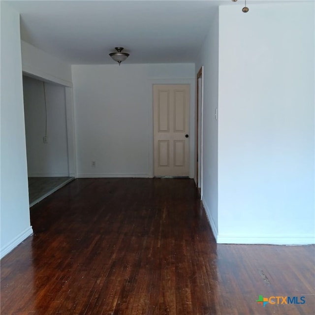 spare room featuring dark hardwood / wood-style flooring